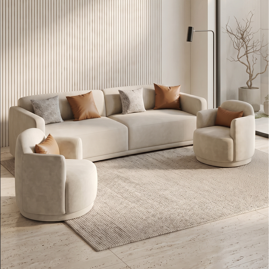A modern living room set featuring a cream-colored three-seater sofa, two matching barrel armchairs, and decorative throw pillows, arranged on a textured rug in front of a slatted wood wall.