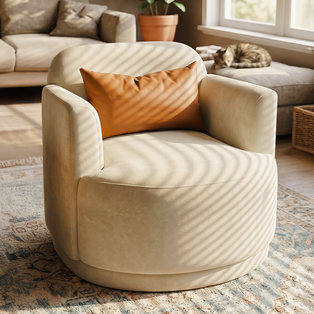 A cream-colored upholstered accent chair with a round base and a rust-orange throw pillow, styled in a sunlit living room with a patterned rug, sofa, and a cat resting on a chaise.